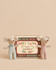 Two small Maileg Family Breakfast Set mice standing in front of a decorative matchbox labeled “The Match Factory Baby Twins.”