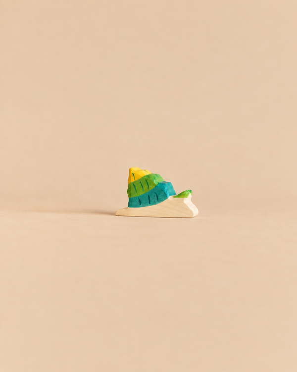 Holztiger Snail handcrafted wooden toy with a yellow and green shell.