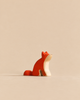 Handmade Holzwald Sitting Fox, a minimalist wooden figurine painted orange and natural wood, designed for imaginative play.