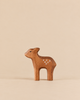 A small, handmade Holzwald Deer, Standing Fawn figurine with white spots on its back, perfect for imaginative play.