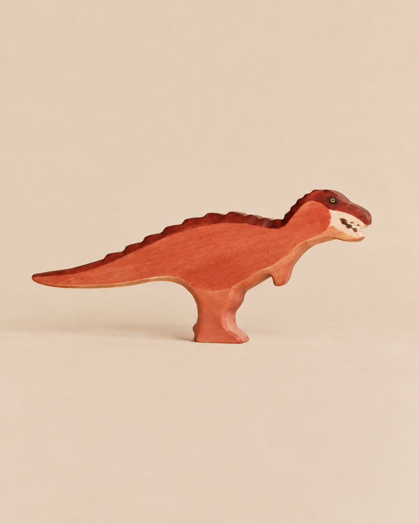Handmade Holzwald Dinosaur - T-Rex Maroon, a maroon-painted wooden toy with visible teeth, crafted as a sustainable toy.