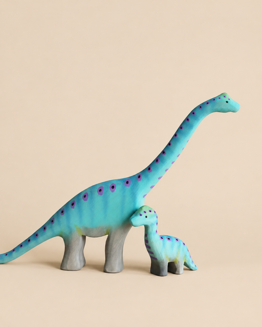 Bumbu Handmade Wooden Brontosaurus Dinosaur Set featuring two handcrafted wooden figures, one large and one small, both blue and decorated with purple spots.