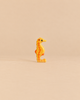 Holztiger Seahorse, a handcrafted wooden toy in yellow with orange stripes.