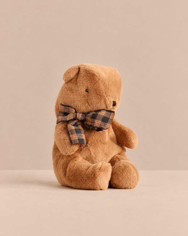 Small Maileg Teddy Bear Plush, Mushroom, in brown, wearing a brown and black plaid bow tie.