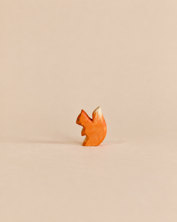 Handmade Holzwald Small Squirrel figurine featuring orange fur and a cream-colored tail tip, crafted as a sustainable wooden toy.
