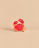 Handcrafted Holztiger Crab wooden toy painted in shades of red and orange.