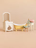 Maileg Bathtub Set featuring a sink dresser with a mirror, a yellow clawfoot tub, a small stool with a rubber duck, and a side table with bathing accessories.