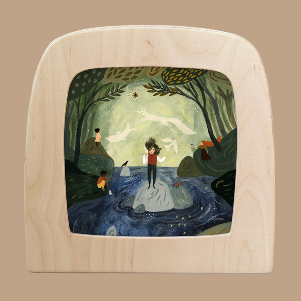 A whimsical light wood-framed illustration shows a person on rocks in a stream, with trees, animals, children, and glowing stars featuring the Silhouette Only - Seashell for Toverlux Lamp in the night sky.
