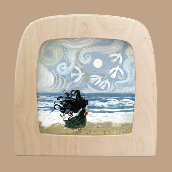 A light wood-framed "Silhouette Only - Tide for Toverlux Lamp" shows a girl with flowing black hair on a beach, facing wavy seas and a swirling sky as white birds circle a bright sun or moon, recalling Magic Silhouettes.