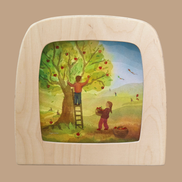The Silhouette Only - Apple Tree for Toverlux Lamp shows a child on a ladder picking apples while another collects them in a basket, set in a vibrant outdoor scene with people and birds in the background.