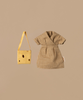 A small brown plaid dress lies next to a yellow tote bag with small holes, evoking an accessory for Maileg Mum Mouse - Light Brown (ships in one week). Both items rest on a plain beige background, crafting a charming scene.