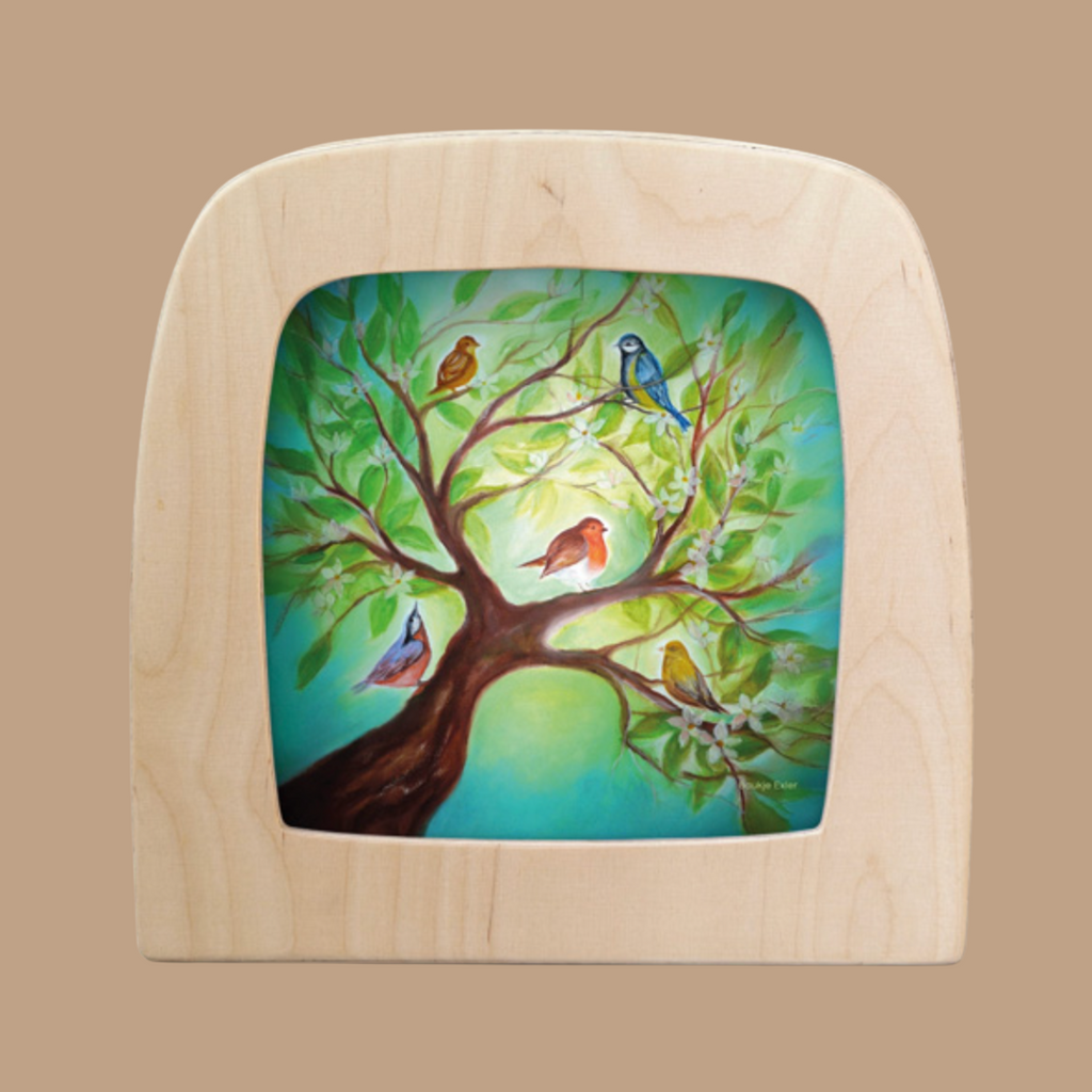 The "Silhouette Only - Birds for Toverlux Lamp" features a wooden frame illustrating birds perched on branches against a bright green background, creating a vibrant and serene nature scene.
