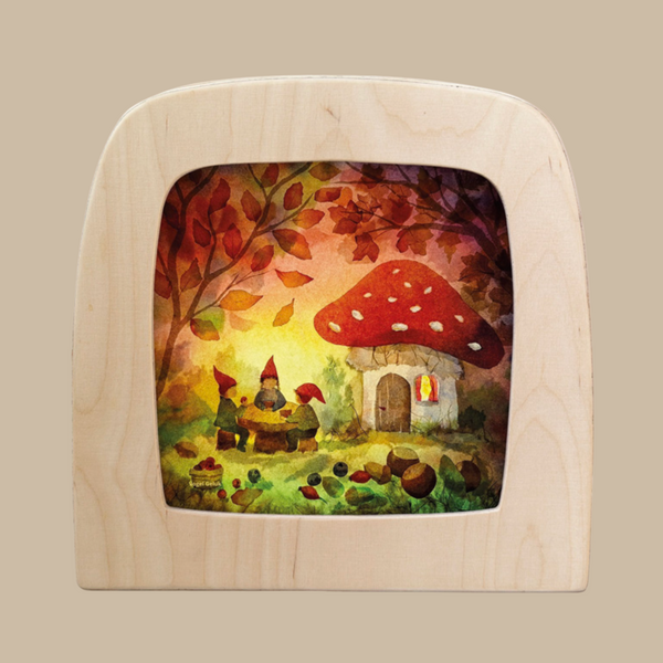 The Silhouette Only - Gnome Picnic for Toverlux Lamp features two gnomes outside a mushroom house, surrounded by autumn leaves and acorns beneath a vibrant sky—a charming decorative accent for your home.