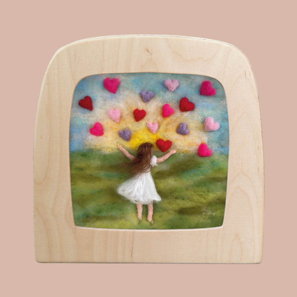 The "Silhouette Only - Hearts for Toverlux Lamp" features a girl in a white dress with long brown hair on grass, reaching toward colorful felted hearts—a charming Magic Silhouettes artwork for your home.