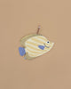 The Butterfly Fish Pencil Case is yellow and cream striped, shaped like a fish with blue fins and tail, features a zipper, and has a pencil partially inside, shown on a plain beige background.