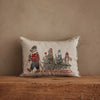 Coral & Tusk Christmas Tree Sled Pillow made of embroidered linen, featuring a bear pulling a sled that carries a Christmas tree, a fox, a llama, and an owl.