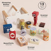 The Groceries Set & Scanner is a 13-piece FSC-certified wooden playset with a white-and-wood shopping basket, red scanner, and colorful pretend boxes, jars, and cans featuring printed barcodes for imaginative play.