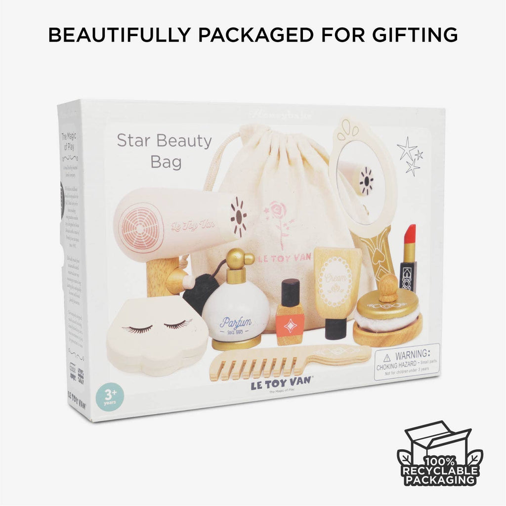 A box labeled "Vanity Star Beauty Kit" displays a kids' wooden makeup toy set with accessories and a drawstring bag. Text above reads "Beautifully packaged for gifting," with a "100% recyclable packaging" symbol. Ideal for imaginative role-play.