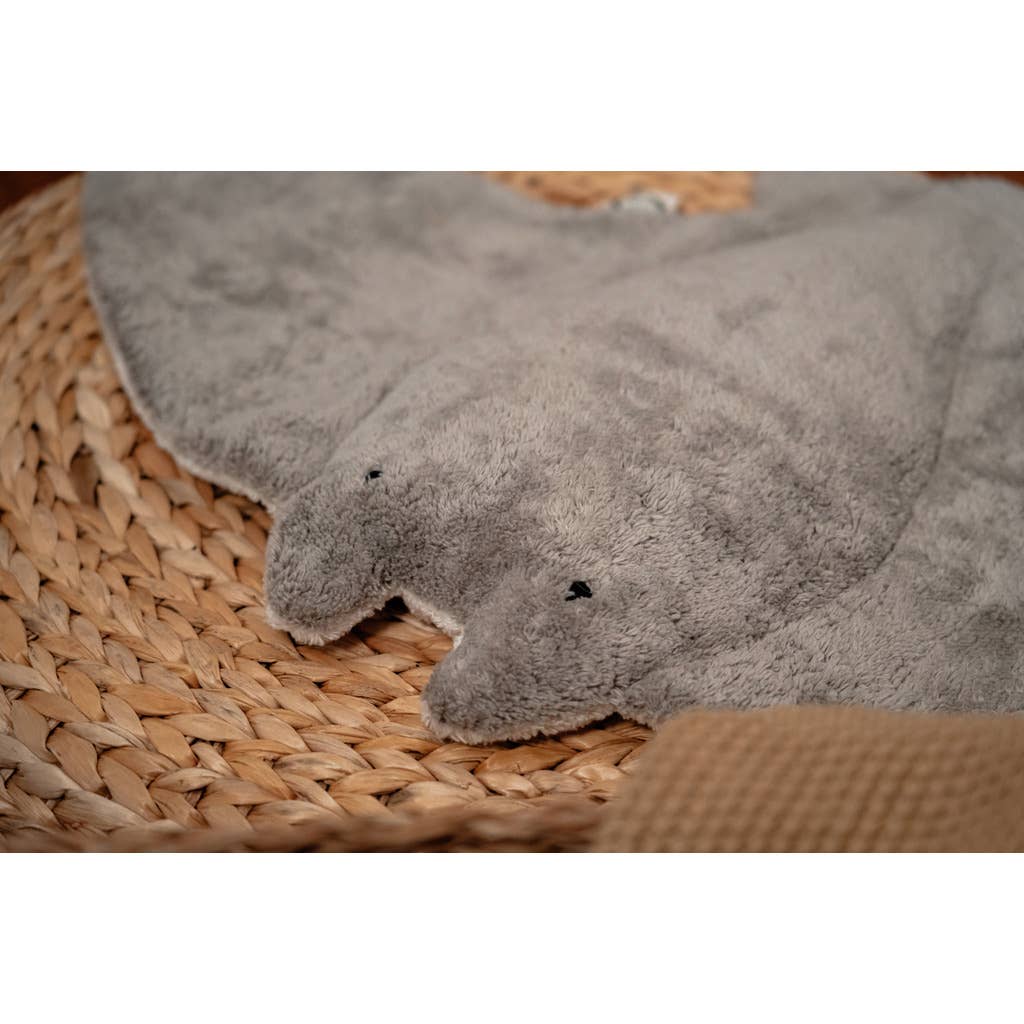 The Senger Naturwelt Stuffed Animal - Large Manta Ray is a soft, gray plush toy with black stitched eyes and a smooth texture, perfect for snuggling. It rests beautifully on any woven mat and makes an adorable cuddly companion.