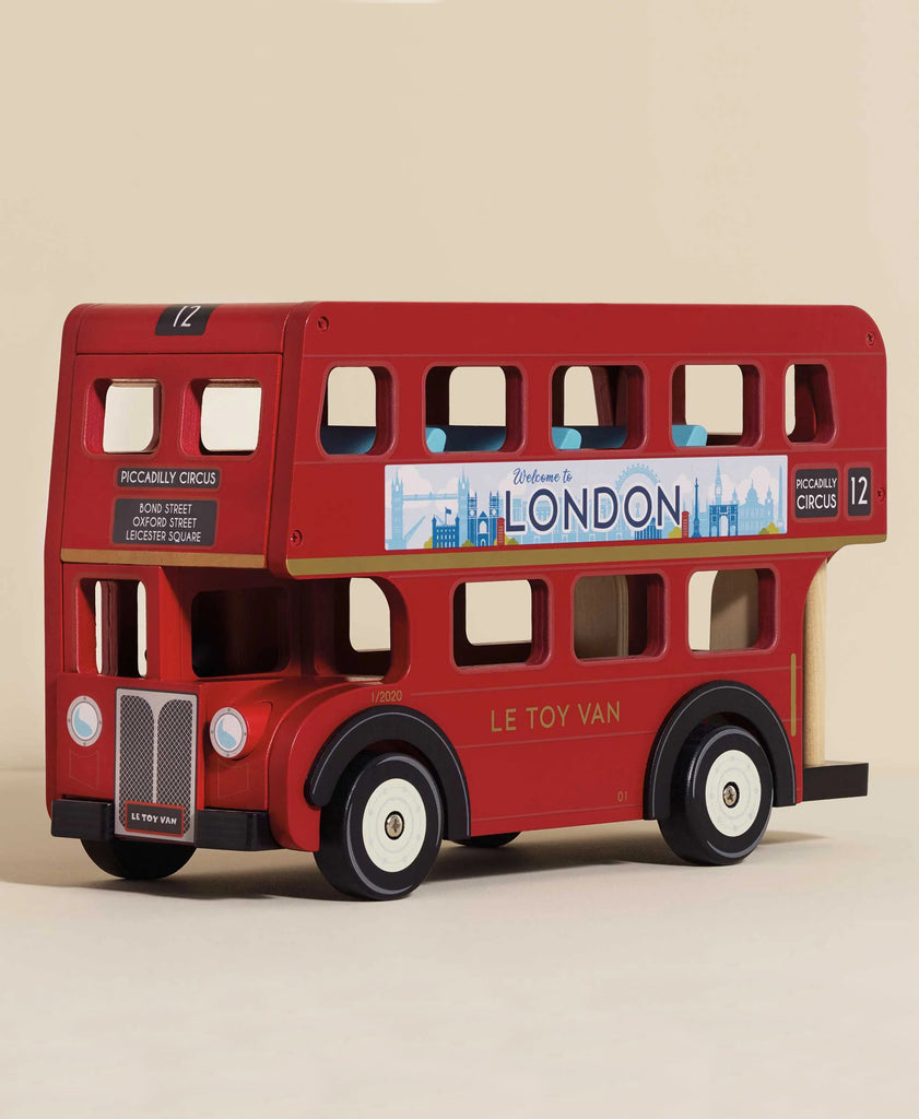 The London Wooden Bus is a red wooden toy featuring "Le Toy Van" on the side, a "Welcome to London" sign, Piccadilly Circus route details, black wheels, and open windows—perfect for early learning fun.