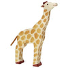 A handcrafted wood giraffe figure with a cream-colored body adorned with brown spots. It stands upright on four legs, has a small tuft on its tail, and red-brown detailing on its hooves and the top of its head. The high quality Holztiger Giraffe, Head Raised showcases a simple, playful design.