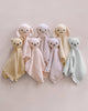 The Cuddle + Kind Organic Cotton Baby Bear Lovey (Honey) features a plush bear head with round ears and a matching soft organic cotton blanket body, perfect as a pastel-colored security blanket for babies.
