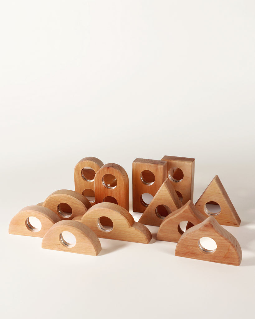 Bauspiel Mirror Blocks, 12-Piece Set: twelve wooden construction blocks, each featuring a circular mirror inlay.