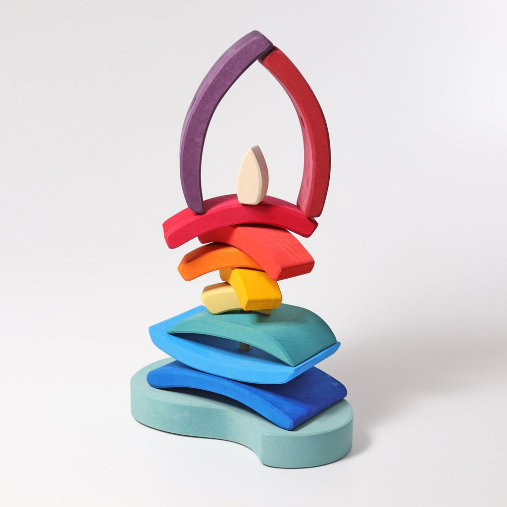 The Grimm's Stacking Tower Sailboat features colorful arch-shaped wooden pieces inspired by classic stacking toys, helping develop fine motor skills while bringing vibrant charm to any playroom.