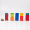 A snail shell sits to the left of five vertical stacks of colorful Grimm’s Stepped Counting Blocks - Large of varying heights.