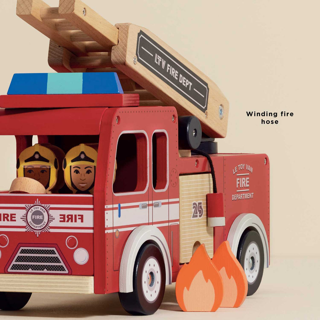 The Wooden Toy Fire Engine & Characters is a retro red fire truck featuring "FIRE DEPARTMENT" and "25" on the side, a movable ladder, two firefighter figures, wooden flames, and a winding fire hose for sustainable play.