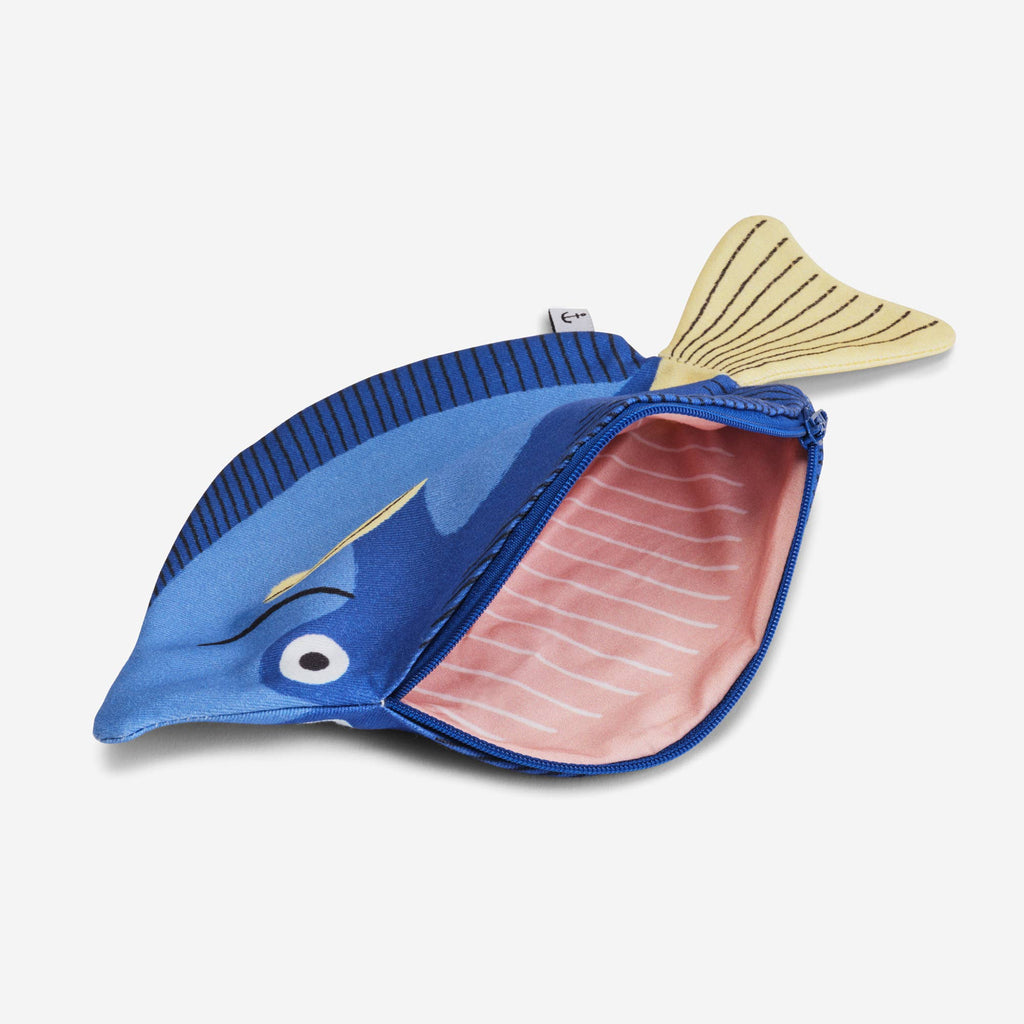 The Surgeon Fish Pencil Case is a blue, cotton, fish-shaped case with a yellow tail and a zippered opening that reveals a pink-striped inner lining.
