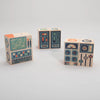 Three Uncle Goose Environments Space Blocks decorated with colorful, abstract designs that resemble control panels or machine interfaces of a rocket ship, positioned against a plain white background.