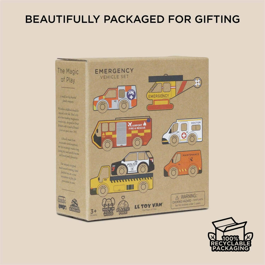 A cardboard box labeled "Emergency Helicopter & Rescue Cars" features colorful illustrations of six wooden toy vehicles, with text saying "Beautifully packaged for gifting," "100% recyclable packaging," and perfect for imaginative play.