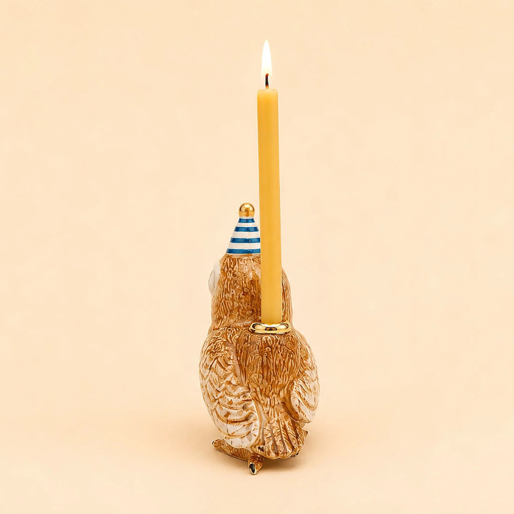 The Barn Owl Cake Topper—offered as a final sale item—is a handcrafted collectible ceramic figurine featuring an owl adorned with a blue-striped party hat and carrying a lit yellow candle on its back, photographed against a plain beige background.