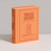 The Jenga Vintage Bookshelf Edition comes in an orange, book-shaped box with a line drawing of a Jenga tower—ideal for family game night, ages 6+, and one or more players.