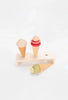 Two Handmade Ice Cream Cones and a toy popsicle, all coated with non-toxic water-based paint, displayed on a minimalist wooden stand against a white background.