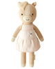 Cuddle + Kind Kelsie the Pony is a hand-knit, fair trade doll made in Peru. It features beige yarn, a cream mane, a pink dress with butterfly detail, embroidered eyes, a smiling mouth, and blushing cheeks.