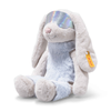 The 12-inch Steiff Hoppie Rabbit in Ski Outfit sits upright, featuring light gray fur, floppy ears, a soft blue belly, iridescent glasses, and a yellow tag on its left ear.