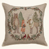 Coral & Tusk Christmas Cheer Wreath Pillow, a square embroidered linen pillow featuring a bear, fox, and reindeer surrounded by a holiday wreath of pine branches, berries, and two cardinals.
