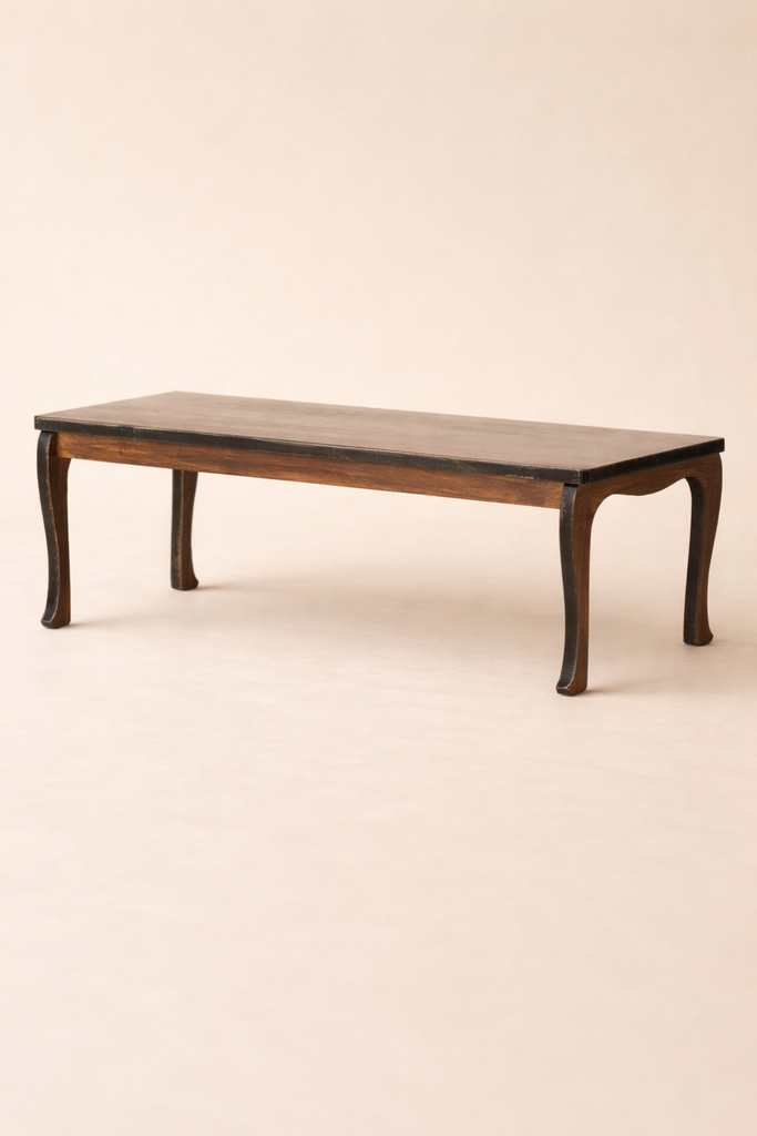 A low, dark wooden table with four curved legs from the Maileg Grand Dining Room Set, perfectly sized for a Maileg Mouse Size dollhouse, set against a plain, light-colored background.