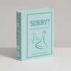 A light blue, fabric-wrapped box styled as a book features the title "Sorry! Vintage Bookshelf Edition" and two game pieces, designed to resemble a collectible bookshelf edition of the classic Sorry! game.