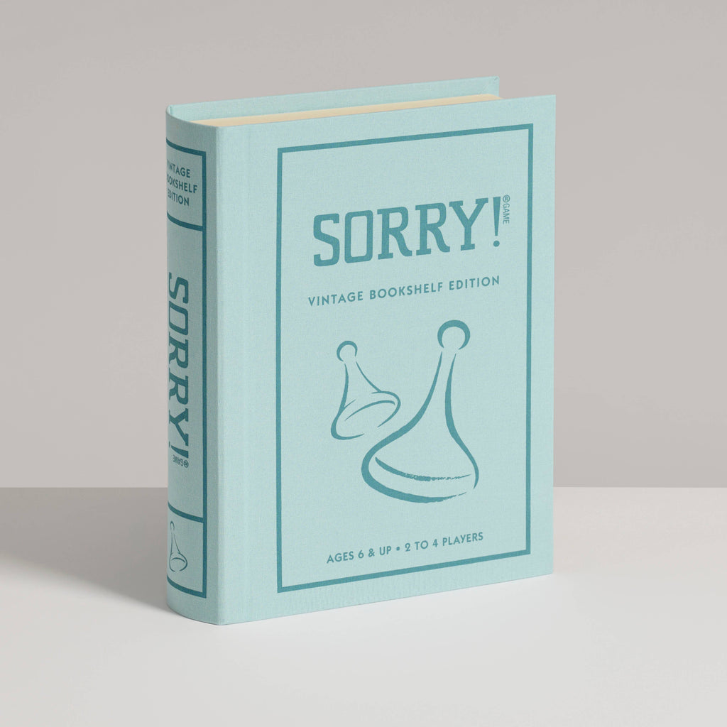 A light blue, fabric-wrapped box styled as a book features the title "Sorry! Vintage Bookshelf Edition" and two game pieces, designed to resemble a collectible bookshelf edition of the classic Sorry! game.