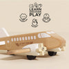 The Wooden Toy Plane rests on a beige surface with icons above for imagination, dexterity, and coordination. Made from FSC®-certified wood, it encourages kids to “Learn, Discover, Play” in a plastic-free way.