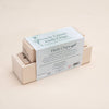 A wooden box featuring "Uncle Goose Chips - Herbs" is displayed. The sustainable basswood packaging showcases a label adorned with herbal illustrations, detailing 24 chips with garden flavors and culinary herb information, plus three elegant display stands.