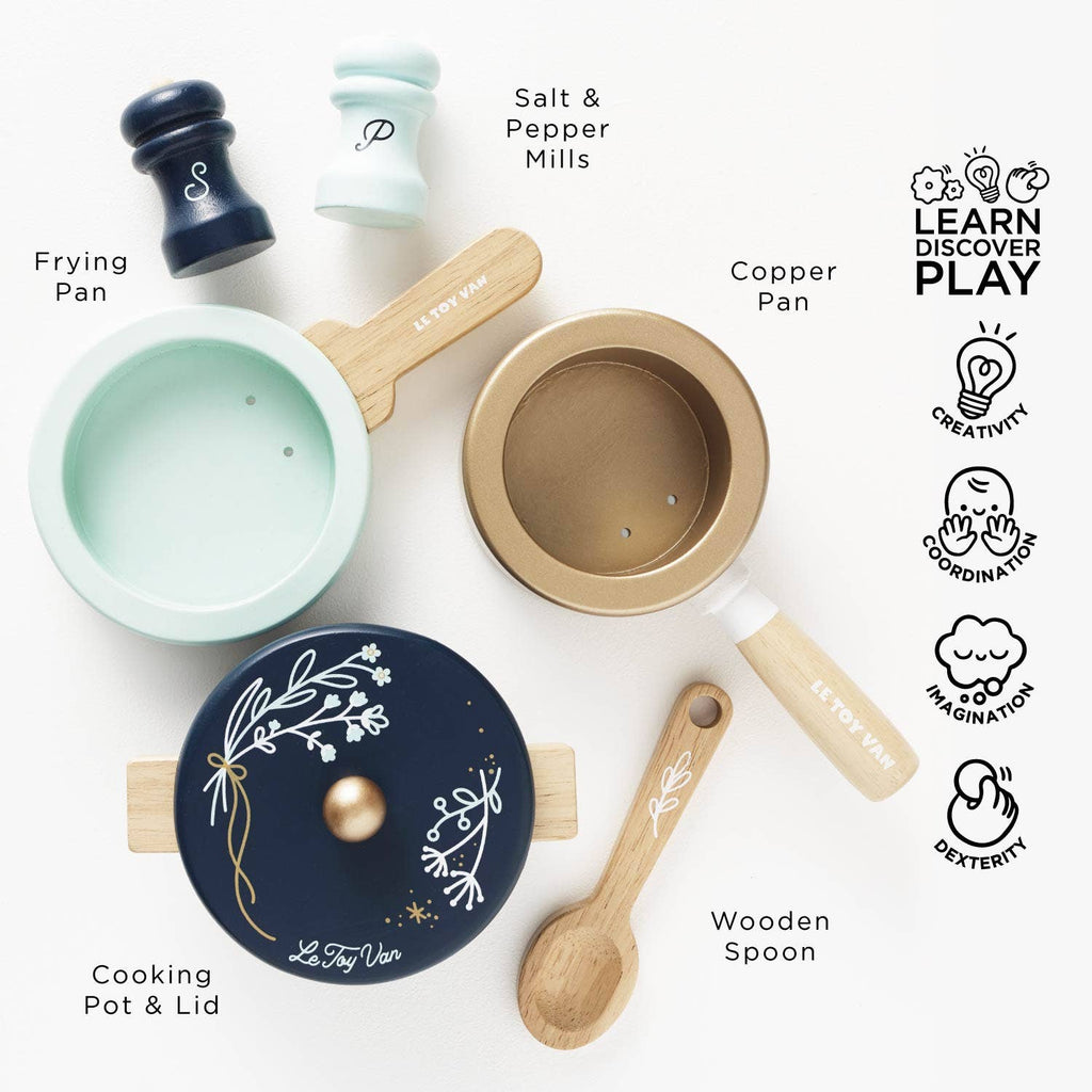 Pots & Pans Kitchen Accessories set featuring a frying pan, copper pan, lidded pot, wooden spoon, and salt and pepper mills, with labels and icons highlighting developmental skills for pretend play.