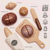 The Artisan Bread and Knife Set (ships in one week) includes a croissant, seeded loaf, country loaf, baguette, bread knife, and baguette bag—arranged with labels and educational icons for fun pretend kitchen play.