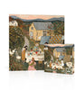 A September Harvest Mini - 100 Piece Mini Puzzle stands upright next to its box, both featuring a harvest table illustration of people picnicking outside a barn with quilts drying on a fence.