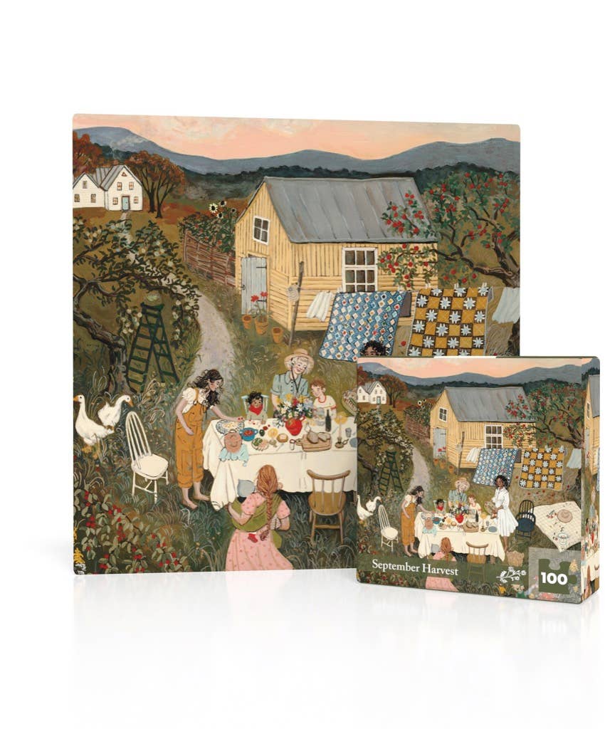 A September Harvest Mini - 100 Piece Mini Puzzle stands upright next to its box, both featuring a harvest table illustration of people picnicking outside a barn with quilts drying on a fence.
