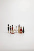 A set of Sabo Concept Christmas Ornaments, featuring hand-painted wooden pieces like a nutcracker set, ballerina, rocking horse, church, fir tree, and crown bear, arranged on a white surface with a minimalist background.