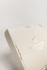 A close-up of the elegant Sabo Concept Christmas Ornaments box, cream-colored with gold designs and "Nutcracker" text on the lid, showcasing hand-painted wooden nutcracker ornaments against a plain white background.